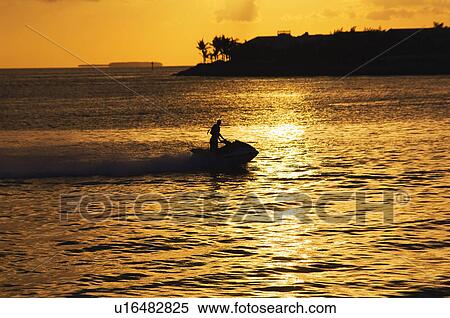 Stock Photography - Jet ski at sunset. Fotosearch