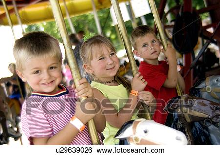 Kids on merry go round View Large Photo Image Stock Photograph - Kids on merry go round. Fotosearch