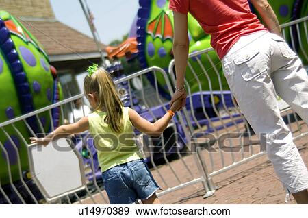 Stock Photo - Mother and daughter at carnival. Fotosearch