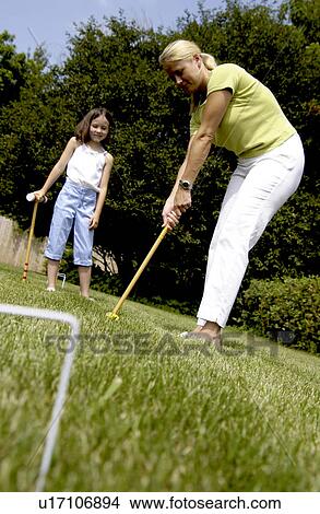 Picture - Mother and daughter playing croquet. Fotosearch