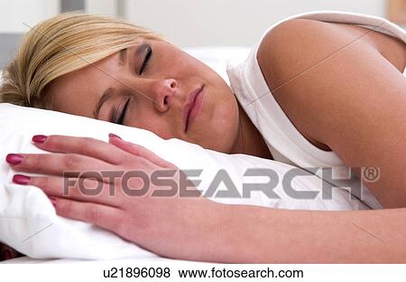 Woman sleeping in bed View Large Photo Image Stock Photo - Woman sleeping in bed. Fotosearch