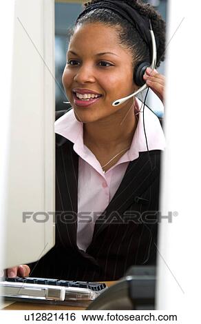 Stock Photograph - African American woman at computer. Fotosearch