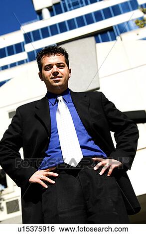 Stock Photograph - Businessman in front of office building. Fotosearch