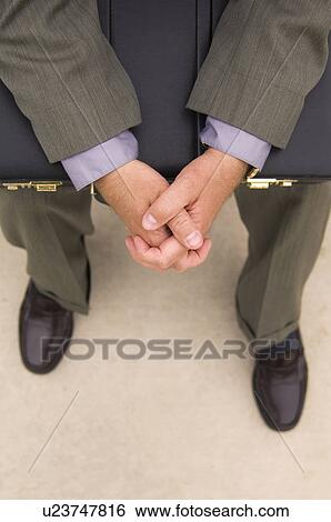 Businessman with briefcase sitting on bench View Large Photo Image Stock Photograph - Businessman with briefcase sitting on bench. Fotosearch