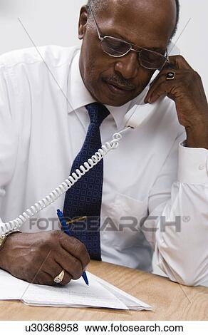 Stock Photo - Businessman working. Fotosearch