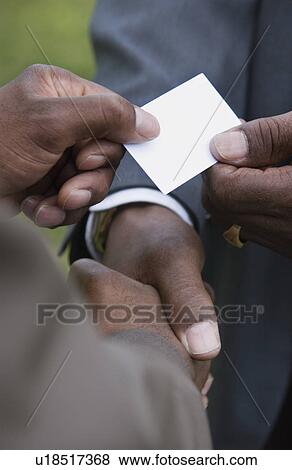 Businessmen exchanging business cards View Large Photo Image Stock Photo - Businessmen exchanging business cards. Fotosearch