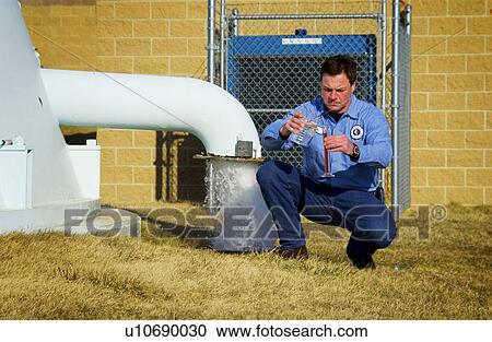 Stock Image - Water Department technician. Fotosearch