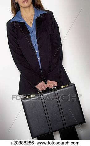 Stock Photograph - Woman holding briefcase. Fotosearch