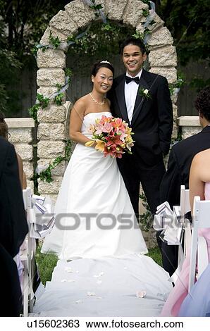 Stock Image - Bride and Groom at altar. Fotosearch