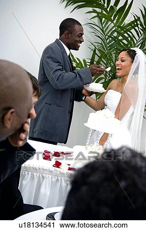 Bride and groom cutting cake View Large Photo Image Stock Image - Bride and groom cutting cake. Fotosearch