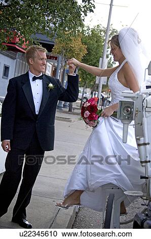 Bride and groom getting out of carriage View Large Photo Image Stock Image - Bride and groom getting out of carriage. Fotosearch