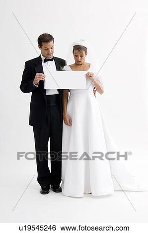 Bride and groom holding blank sign View Large Photo Image Stock Photograph - Bride and groom holding blank sign. Fotosearch