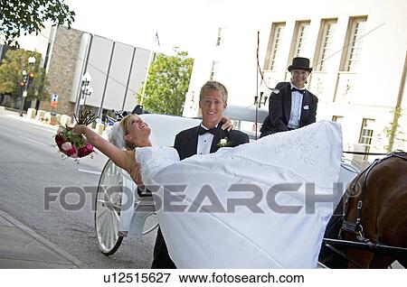 Bride and groom in front of horse and carriage View Large Photo Image Stock Photo - Bride and groom in front of horse and carriage. Fotosearch