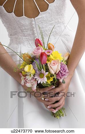Stock Image - Bride holding bouquet. Fotosearch
