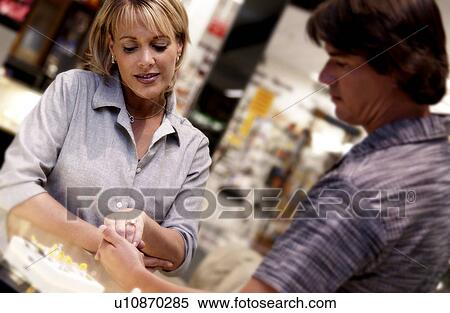 Stock Photography - Couple looking at rings. Fotosearch