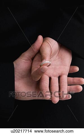 Picture - Groom with ring behind back. Fotosearch