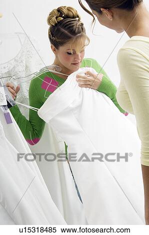 Stock Photography - Woman choosing bridal gown. Fotosearch