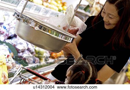 Asian mom and daughter shopping for groceries View Large Photo Image Picture - Asian mom and daughter shopping for groceries. Fotosearch
