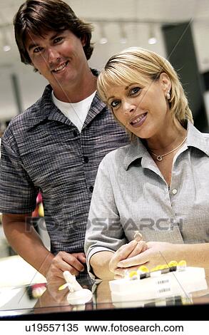 Couple looking at rings View Large Photo Image Stock Photography - Couple looking at rings. Fotosearch