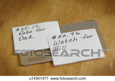 Stock Photo - Credit cards with listing of gifts to purchase. Fotosearch