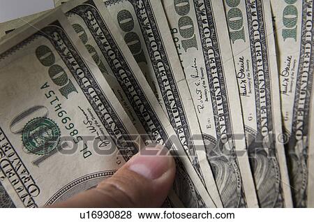 Stock Photo - Man holding money. Fotosearch