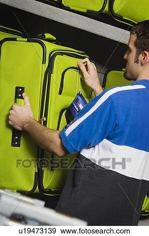 Man shopping for luggage View Large Photo Image Stock Photo - Man shopping for luggage. Fotosearch