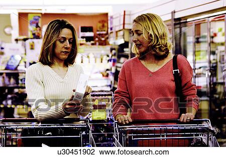 Two women grocery shopping View Large Photo Image Stock Image - Two women grocery shopping. Fotosearch