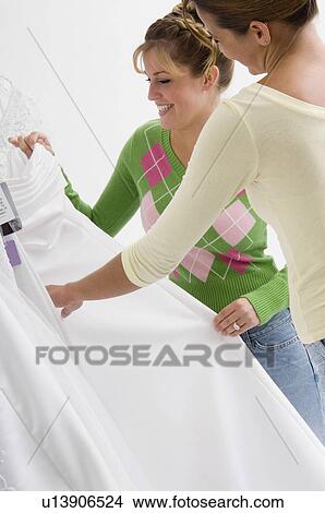 Woman choosing bridal gown View Large Photo Image Picture - Woman choosing bridal gown. Fotosearch