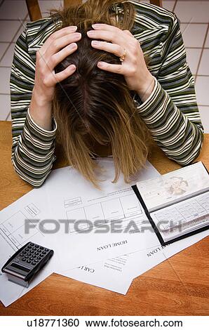 Stock Image - Woman paying bills. Fotosearch
