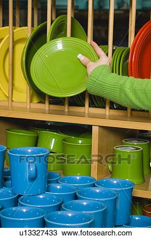 Stock Image - Woman shopping for dishes. Fotosearch