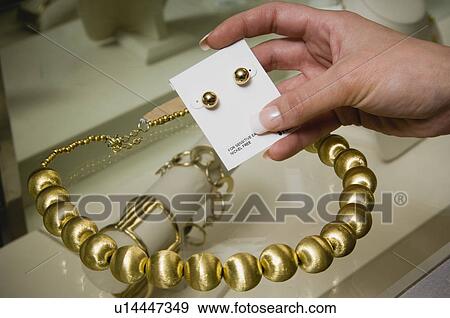 Stock Photo - Woman shopping for jewelry. Fotosearch