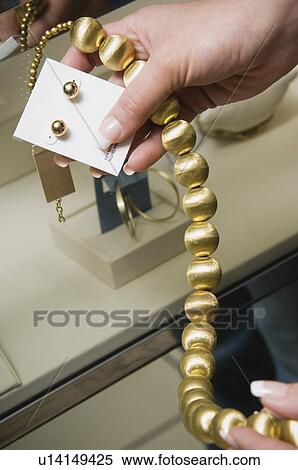 Stock Photography - Woman shopping for jewelry. Fotosearch