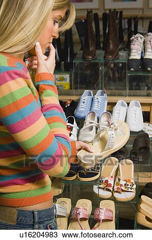 Stock Image - Woman shopping for shoes. Fotosearch