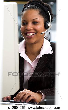 Stock Image - African American woman at computer. Fotosearch