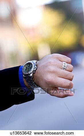 Stock Image - Businessman checking his watch. Fotosearch