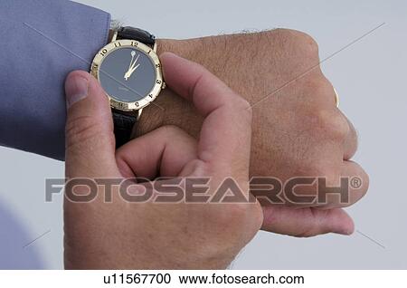 Stock Image - Businessman checking watch. Fotosearch