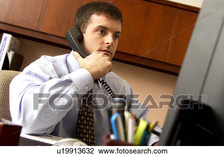 Stock Image - Businessman talking on phone. Fotosearch