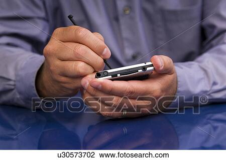 Stock Image - Businessman using PDA. Fotosearch