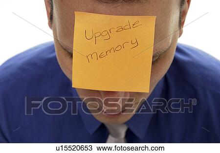 Stock Image - Businessman with post it note on forehead. Fotosearch