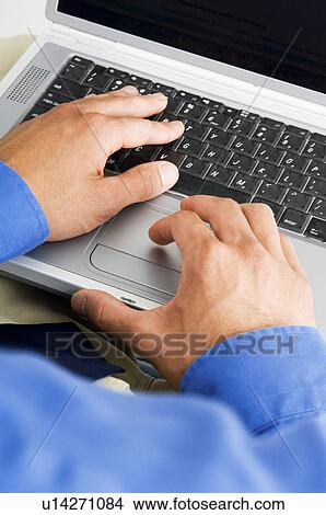 Businessman working on laptop View Large Photo Image Picture - Businessman working on laptop. Fotosearch
