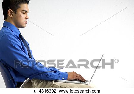 Businessman working on laptop View Large Photo Image Stock Image - Businessman working on laptop. Fotosearch