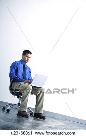 Stock Image - Businessman working on laptop. Fotosearch