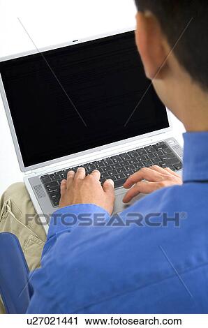 Businessman working on laptop View Large Photo Image Stock Image - Businessman working on laptop. Fotosearch