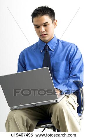 Stock Photography - Businessman working on laptop. Fotosearch