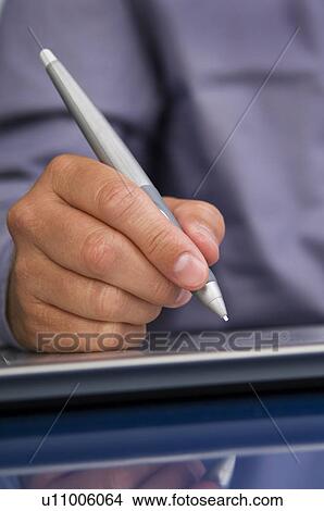 Picture - Businessman writing on computer notepad. Fotosearch