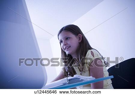 Stock Photograph - Girl at computer. Fotosearch