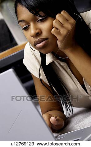 Stock Photo - Girl at laptop. Fotosearch