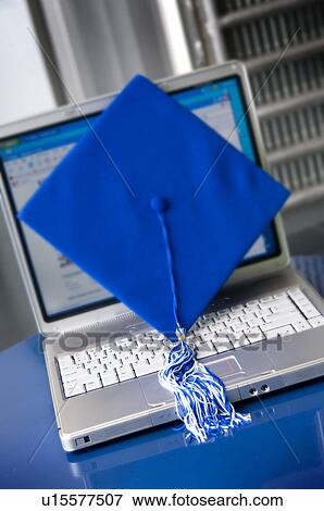Stock Photo - Graduation cap and tassel setting on laptop computer. Fotosearch
