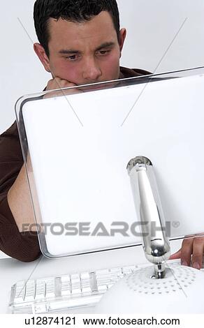 Stock Image - Hispanic man working at computer. Fotosearch