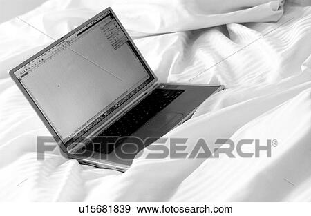 Stock Photo - Laptop on a bed. Fotosearch